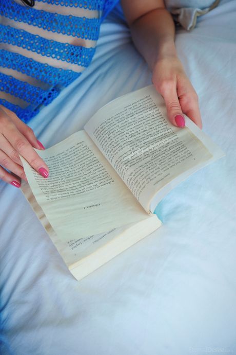 Skinny teen Dita V fingers her pussy in blue thigh high socks on a bed