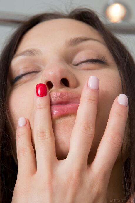 Beautiful teen Taini A gets naked in a bathroom and shows her big tits and twat