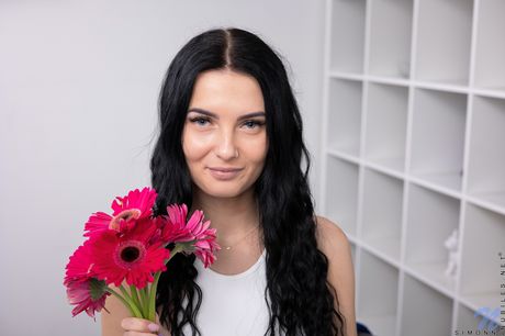 Hot girl with black hair and big tits shows her trimmed pussy in the nude