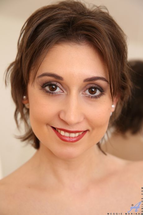 Mature brunette Meggie Marika shows her tiny tits and hairy pussy