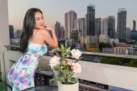 Sexy Asian teen Kahlisa shows off her big tits and hairy pussy on a balcony