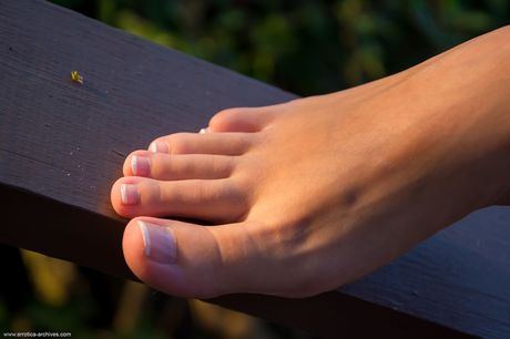 Young beauty Jazz gets completely naked on a balcony overlooking the sea