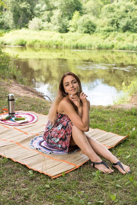 Tender teen Slava goes naked while near a body of water