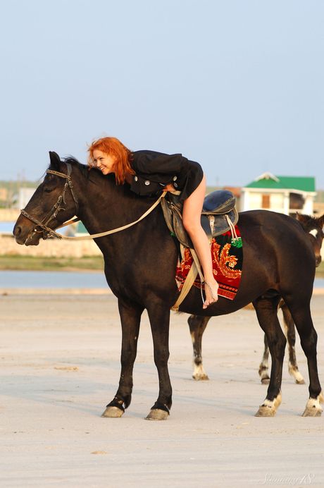Stunning teen Euphrosyne E rides a horse & poses nude on the beach