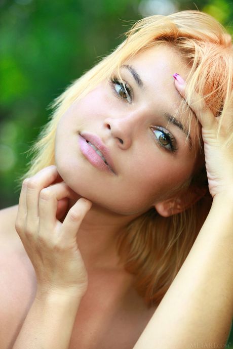 Ukrainian babe Violla A exhibits her big tits and poses naked outdoors