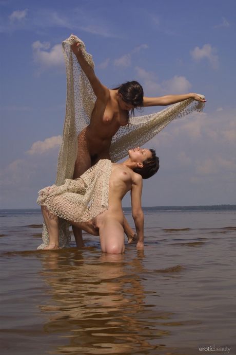 Winsome teen girls Brandy & Bonnie get naked on a sandy beach