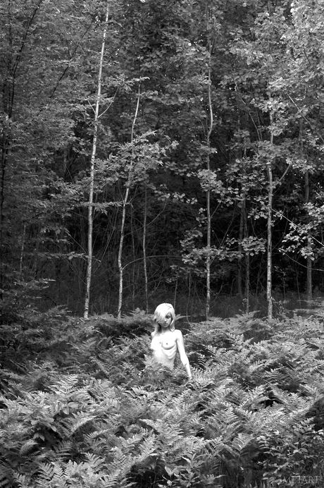 Lean teen Olya A poses naked in the forest & shows her small tits & feet