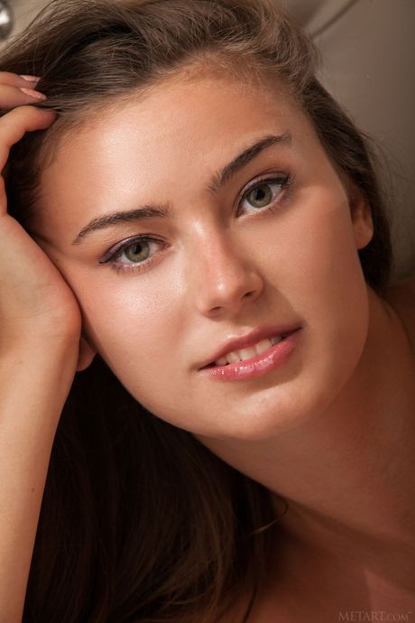 Sweet brunette girl with an athletic body Muse shows her big tits and poses