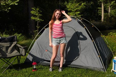 Redheaded teen Myra Glasford fists her pussy after getting naked in nature