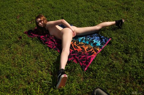 Redheaded teen Myra Glasford fists her pussy after getting naked in nature