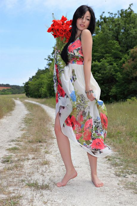 Melani A takes off her black dress and poses naked in the meadow