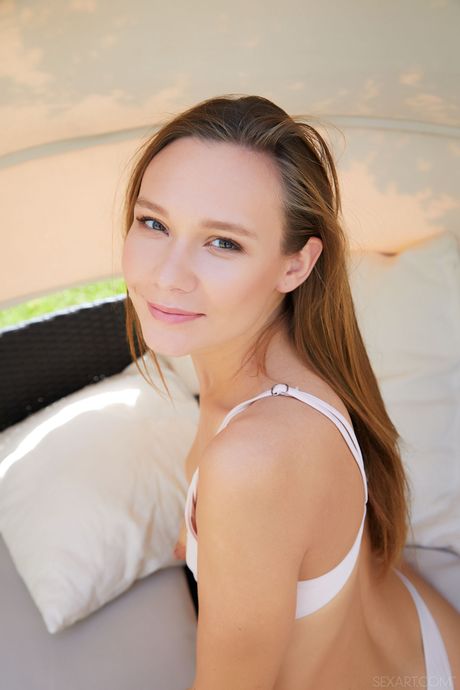 Beautiful teen Mirabella fingers her pussy after getting naked on a sun bed