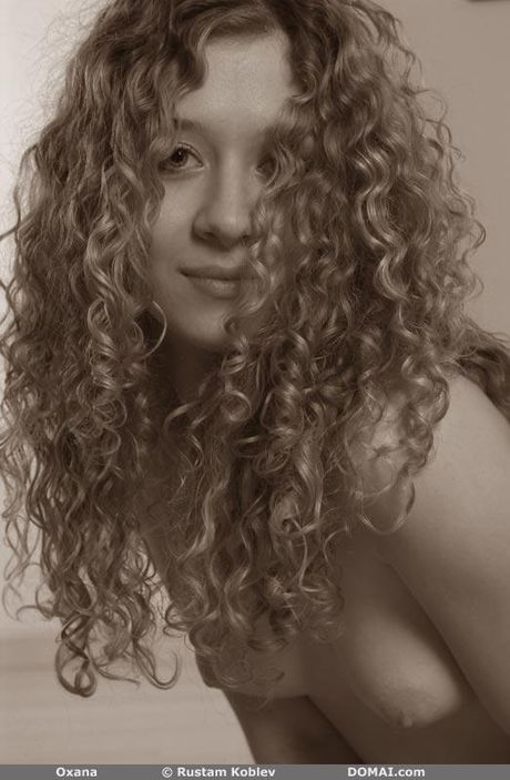 Bashful teen Oxana displays her small tits and poses nude in a solo