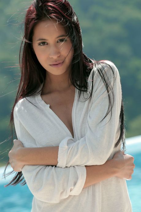 Sexy Asian teen Paula Shy demonstrates her big tits and poses naked