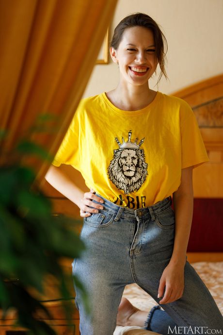 Alluring teen Giselle removes her red robe and lipstick to pose nude on a bed