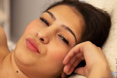 Sexy brunette Ava Black unveils her big tits and shaved pussy in a solo