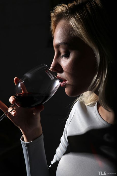 Blonde teen Kira W pours red wine over her naked body in heels