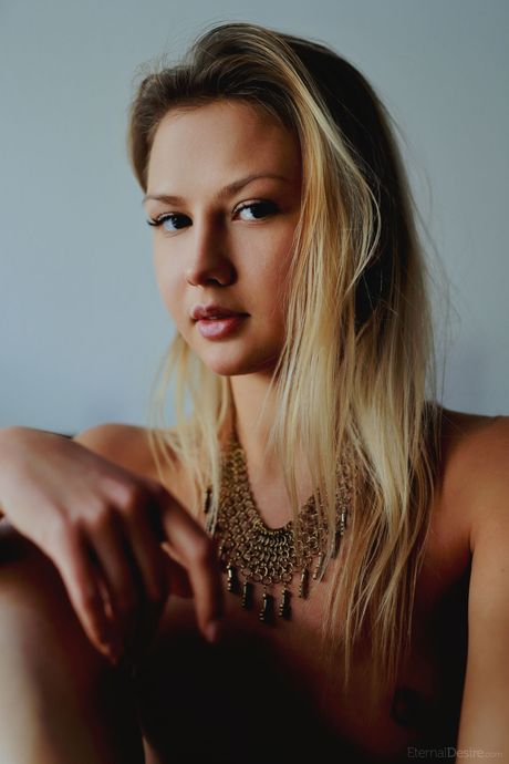 Skinny teen Katrina shows her small tits and poses nude on a hutch