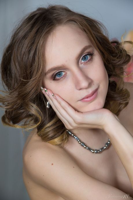 Stunning 18: Blonde teen Angela poses nude in a bedroom with a rug on the floor