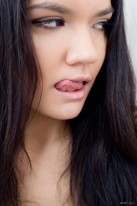 Dalida A highlights her big tits and shaved pussy as she poses in the nude