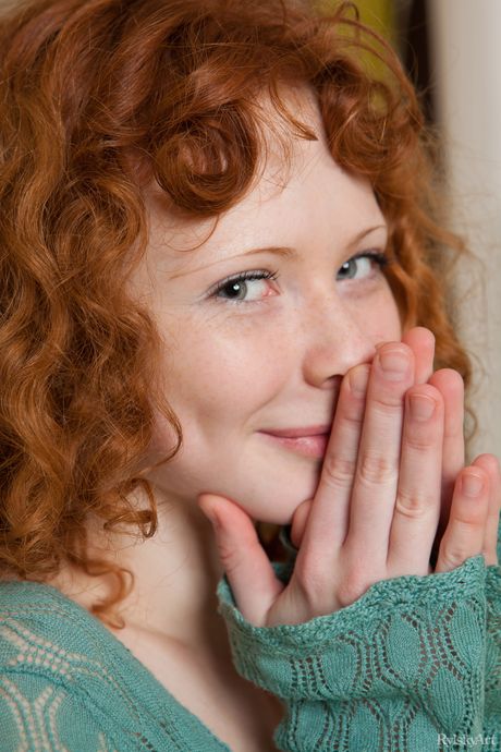 Pretty teen Rochelle highlights her landing strip pussy while naked on a bed