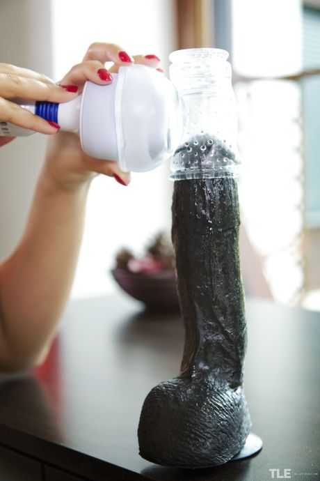 Endearing teen Ornella removes her stockings before masturbating with a dildo