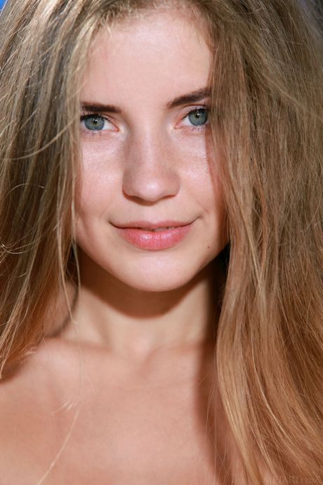 Winsome teen Vivian gets naked in the bleachers while watching a game