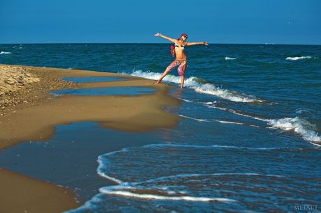 Ukrainian babe Karoline A strips and poses naked on the beach