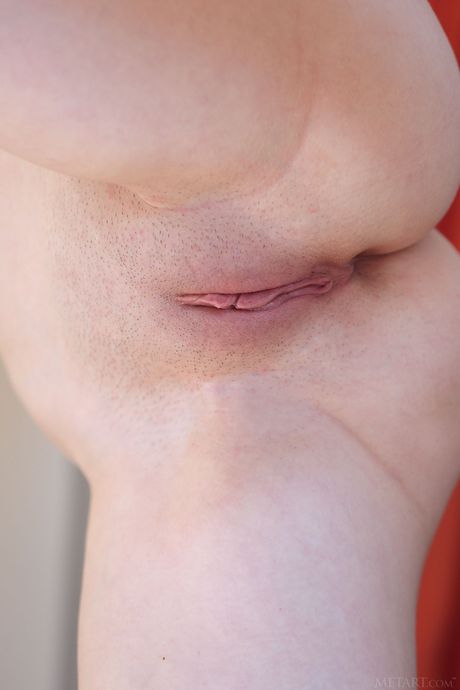 Intriguing teen Serena Wood removes her bikini to pose nude on a patio