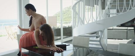 Lesbian girls Kira Queen & Henessy A have sex on a table in the kitchen