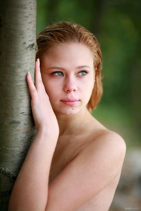 Cute teen Krissta A shows her tiny tits & reveals her naked form in the forest