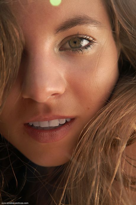 Lean teen Antea highlights her tight slit while naked on a beach