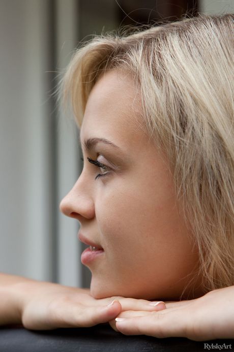 Ligh-haired teen Luciana models totally naked in a garden setting