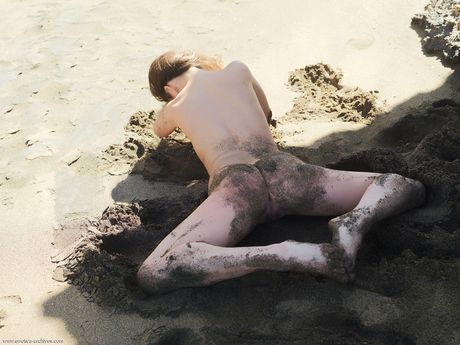 Naked teen girl with a pretty face Lorena poses on a rocky outcropping