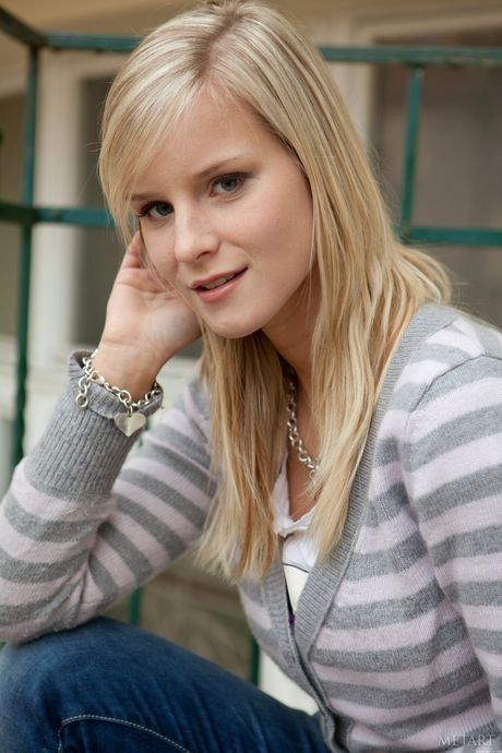 Blonde teen Miela A removes her dress to pose nude with conviction