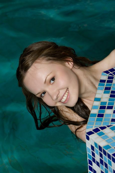 Lean teen Virginia Sun strips and poses naked in the water