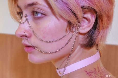 Young blonde Alena sports a spider tattoo while showing her naked body in stockings