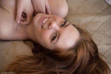 Errotica Archives: Skinny redhead Candy Red exhibits her small tits and poses naked