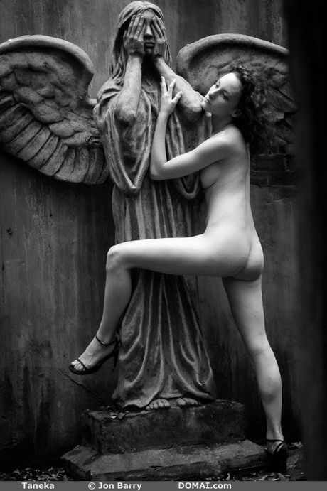 Tall redhead Taneka poses naked in the garden to show her tiny tits & ass