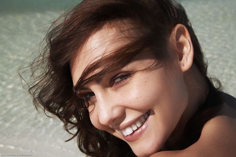 Blonde lesbians Gabriela & Deni get naked on a sandy beach in the nude