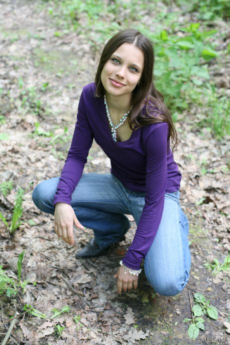 Sexy Russian erotic model Marina O poses naked in the forest wearing boots