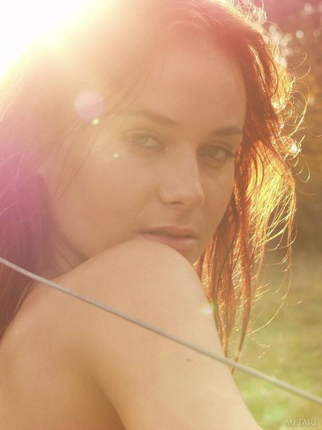 Natural redhead Models No Name gets naked in a field of wildflowers