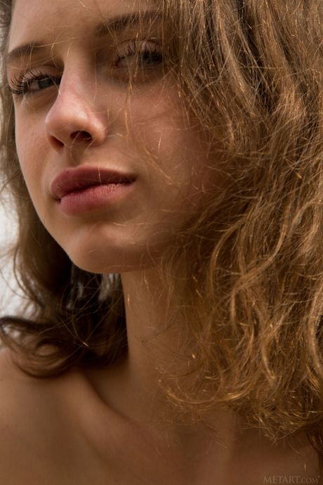 Intriguing teen Clarice shows her big tits & bald pussy in a solo outdoor shoot