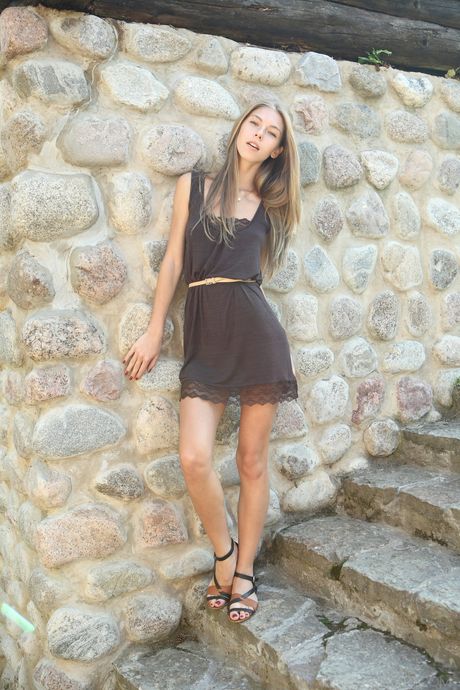 Blonde teen Katherine A gets naked in high heels on a balcony in a sexy manner