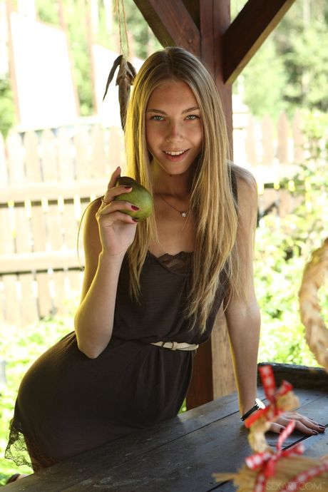 Blonde teen Katherine A gets naked in high heels on a balcony in a sexy manner