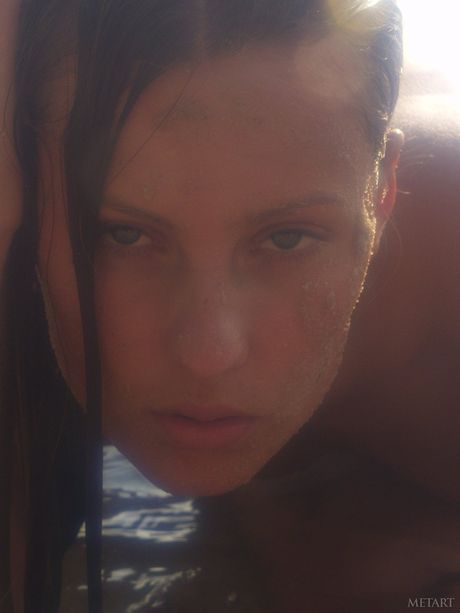 Blonde teen Models No Name gets naked in a shallow stream